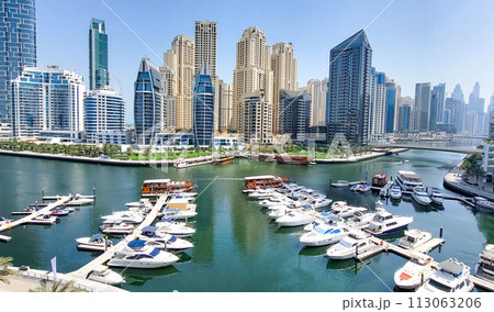 Dubai Marina skyscrapers. Dubai Marina is an artificial channel with a length of 3 km, laid along the coastline of the Persian Gulf Dubai Marina skyscrapers. Dubai Marina is an artificial channel with a length of 3 km, laid along the coastline of the Persian Gulf 113063206