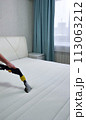 The concept of cleaning and housekeeping. Dry cleaning of the mattress by a professional method. 113063212