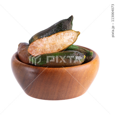 Fresh finger limes in wooden bowl isolated on white background. Caviar lime. Fruits pods. Fresh finger limes in wooden bowl isolated on white background. Caviar lime. Fruits pods. 113064073