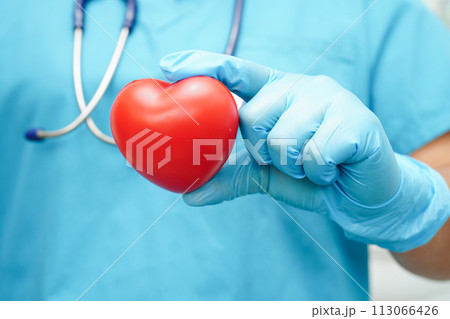 Asian woman doctor holding red heart for health in hospital. Asian woman doctor holding red heart for health in hospital. 113066426