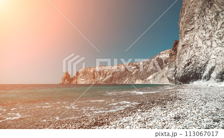 Abstract nature summer ocean sunset sea background. Small waves on water surface in motion blur with bokeh lights from sunrise. Holiday, vacation and recreational background concept 113067017