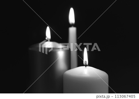 Burning candles on dark surface 113067405