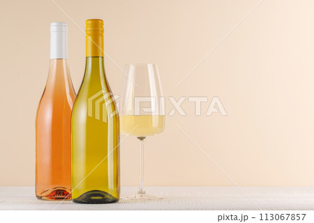 Rose and White Wine Bottles on Table 113067857