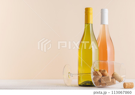 Rose and White Wine Bottles on Table 113067860