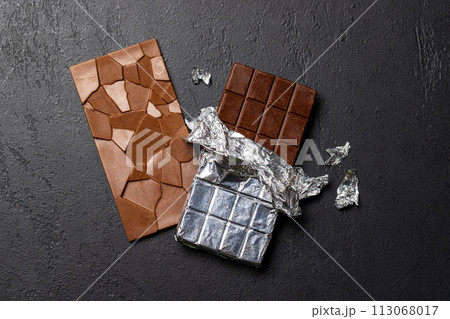Two chocolate bars on stone background Two chocolate bars on stone background 113068017