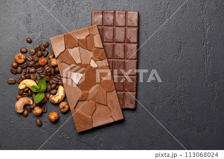 Two chocolate bars isolated on stone background Two chocolate bars isolated on stone background 113068024