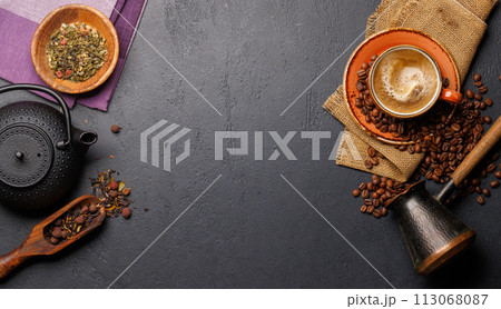 A tantalizing display of roasted coffee beans and dry tea leaves, accompanied by an espresso coffee cup and a teapot A tantalizing display of roasted coffee beans and dry tea leaves, accompanied by an espresso coffee cup and a teapot 113068087