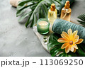 Spa treatment accessories, towels and oil bottles on grey background 113069250