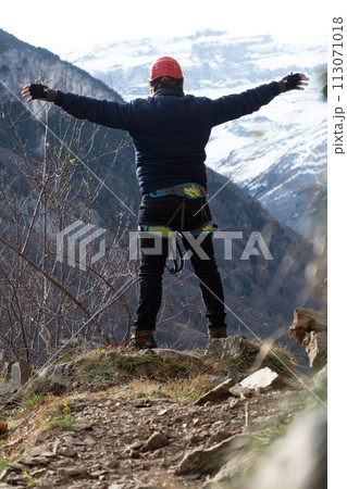 Man in body harnesses feature life-safety, viaferrata in mountains of pyrenees 113071018