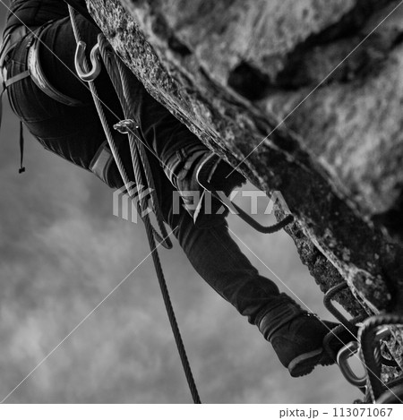 Man in body harnesses feature life-safety, viaferrata in mountains of pyrenees Man in body harnesses feature life-safety, viaferrata in mountains of pyrenees 113071067