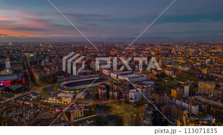City skyline of Italian metropolis at sunset. Panoramic skyline and modern commercial buildings with empty road. Italy, Lombardy, Milan City skyline of Italian metropolis at sunset. Panoramic skyline and modern commercial buildings with empty road. Italy, Lombardy, Milan 113071835