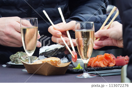 People eating sea food at farmers market. People eating sea food at farmers market. 113072276