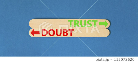 Trust or doubt symbol. Concept word Trust or Doubt on beautiful wooden stick. Beautiful blue table blue background. Business and trust or doubt concept. Copy space. Trust or doubt symbol. Concept word Trust or Doubt on beautiful wooden stick. Beautiful blue table blue background. Business and trust or doubt concept. Copy space. 113072620