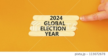 2024 global election year symbol. Concept words 2024 global election year on wooden stick. Beautiful orange table orange background. Voter hand. Business 2024 global election year concept. Copy space. 2024 global election year symbol. Concept words 2024 global election year on wooden stick. Beautiful orange table orange background. Voter hand. Business 2024 global election year concept. Copy space. 113072678