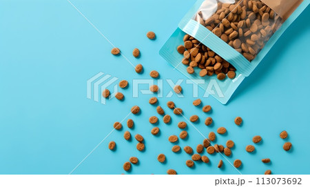 Spilled organic raw almonds from a plastic bag on a blue surface. Healthy snacks concept. Ideal for food and nutrition themes. Minimalist design. AI 113073692
