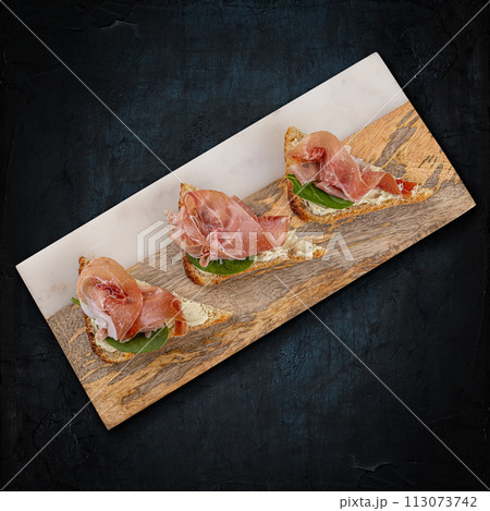 Prosciutto bruschetta with fresh ingredients 113073742
