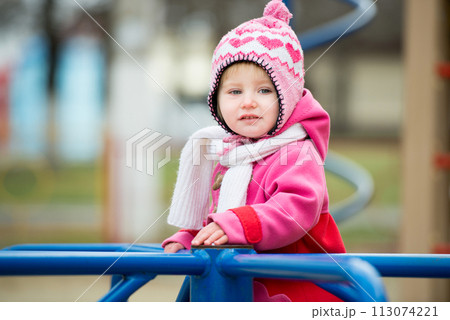 little girl playing on the playground little girl playing on the playground 113074221