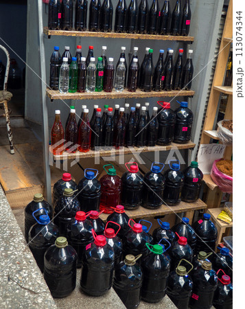 Georgian wine on the counter. Homemade wine in the market. different kinds. Homemade alcohol assortment. Store in Georgia. Drinking from grape juice Georgian wine on the counter. Homemade wine in the market. different kinds. Homemade alcohol assortment. Store in Georgia. Drinking from grape juice 113074344
