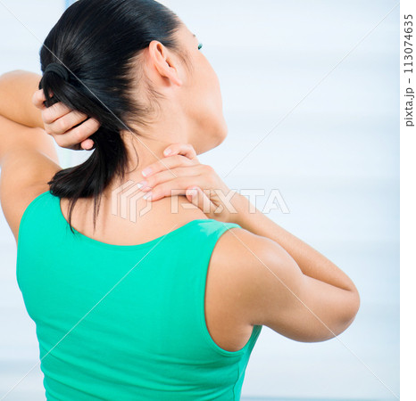 young brunette woman with a pain in the neck young brunette woman with a pain in the neck 113074635