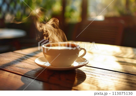 A cup of coffee on a wooden table under the morning sun. 113075130
