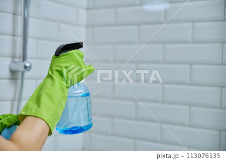 Close-up hands in gloves cleaning bathroom, washing glass in shower Close-up hands in gloves cleaning bathroom, washing glass in shower 113076135