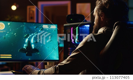 Man shooting asteroids in spaceship flying singleplayer game with overlay HUD showing health, fuel, ammo bars and minimap. Gamer navigating universe in simulation game, close up Man shooting asteroids in spaceship flying singleplayer game with overlay HUD showing health, fuel, ammo bars and minimap. Gamer navigating universe in simulation game, close up 113077405