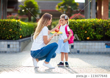 School pick up. Mother and kids after school. School pick up. Mother and kids after school. 113077648