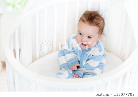 Baby in a white crib. Child in bed. Baby in a white crib. Child in bed. 113077708