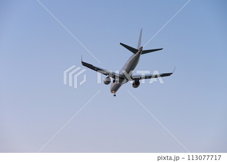 Airplane in the air and sunset in background Airplane in the air and sunset in background 113077717