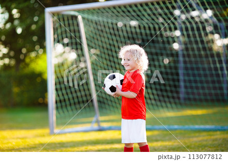Kids play football. Child at soccer field. 113077812