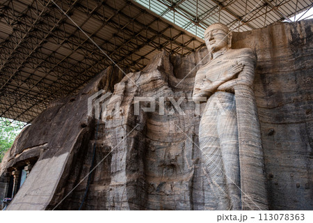 The standing image depicts an unusual mudra is said to be the finest of the series at Gal Vihara in ancient city of Polonnaruwa, Sri Lanka. The standing image depicts an unusual mudra is said to be the finest of the series at Gal Vihara in ancient city of Polonnaruwa, Sri Lanka. 113078363