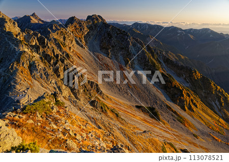 奥穂高岳への登りから見る朝焼けの北穂高岳と槍ヶ岳・大天井岳 奥穂高岳への登りから見る朝焼けの北穂高岳と槍ヶ岳・大天井岳 113078521