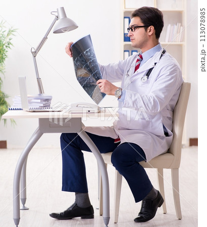 Young handsome doctor working in hospital room Young handsome doctor working in hospital room 113078985