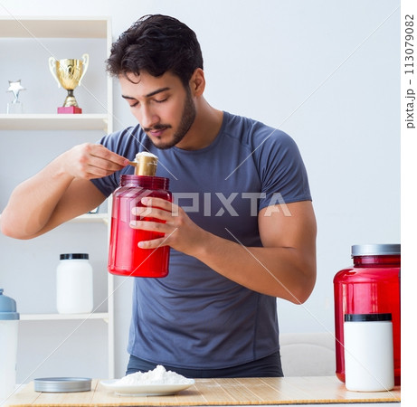 Athlete tasting new protein supplements for better muscles Athlete tasting new protein supplements for better muscles 113079082