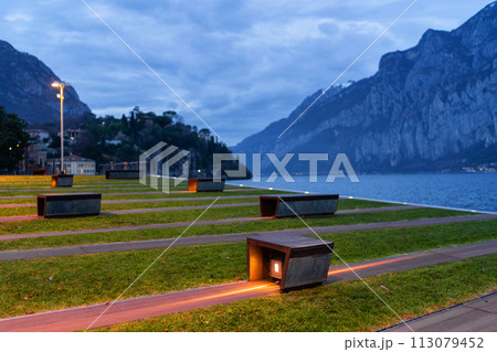 Modern design urban bench in front of the mountain lake Como 113079452