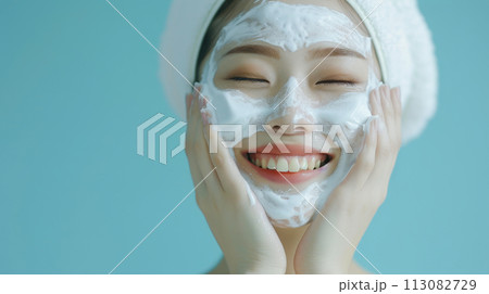 Skincare Face Wash with Smiling Asian Woman Using Foaming Cleanser Mask 113082729