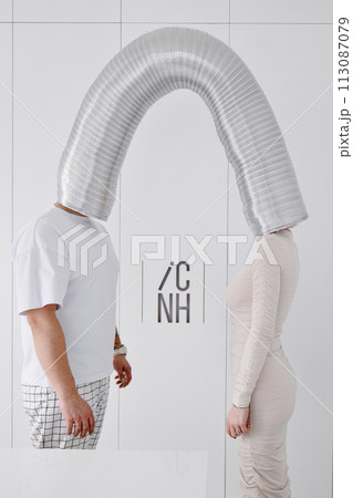 A man and a woman standing next to each other against a wall A man and a woman standing next to each other against a wall 113087079
