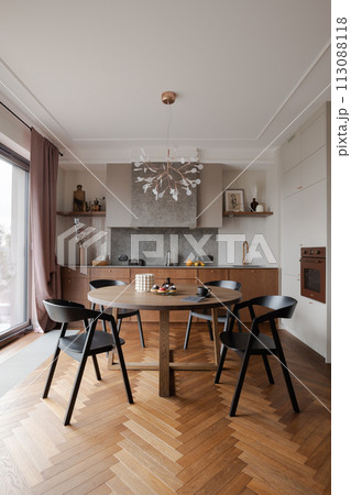 Furniture set in a dining room with hardwood flooring and table and chairs 113088118