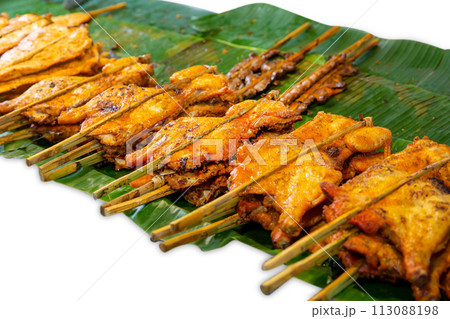 Top view of Grilled chicken on banana leaves, focus selective Top view of Grilled chicken on banana leaves, focus selective 113088198