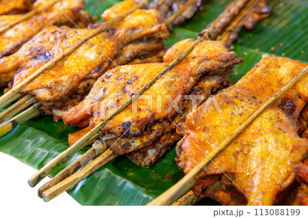 Top view of Grilled chicken on banana leaves, focus selective Top view of Grilled chicken on banana leaves, focus selective 113088199