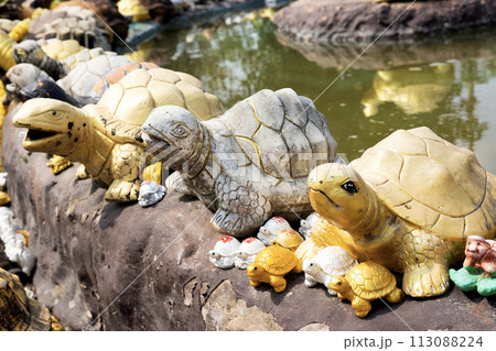 Turtle statue doll used for worshiping sacred things According to Buddhist and Brahmin beliefs. gold and silver color. Statue for worship of Thailand, India, Myanmar. Hand made craft. 113088224