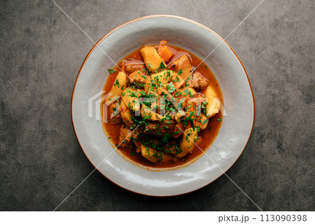 Portion of oriental stewed meat with potatoes Portion of oriental stewed meat with potatoes 113090398