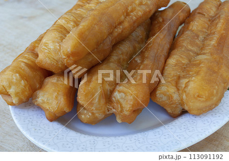 Close up of cakoi or youtiao cake on white plate. Asian food concept 113091192