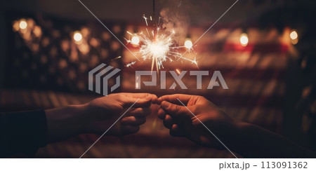 Two hands holding sequins with warm glowing lights on the background of the American flag. Two hands holding sequins with warm glowing lights on the background of the American flag. 113091362