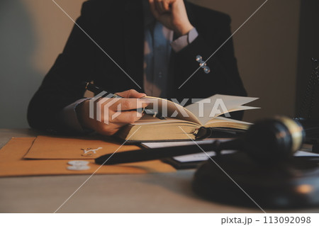 Business and lawyers discussing contract papers with brass scale on desk in office. Law, legal services, advice, justice and law concept picture with film grain effect 113092098
