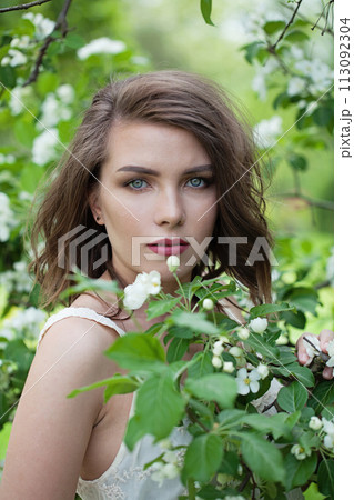 Spring healthy woman posing outdoor in spring park, closeup portrait 113092304