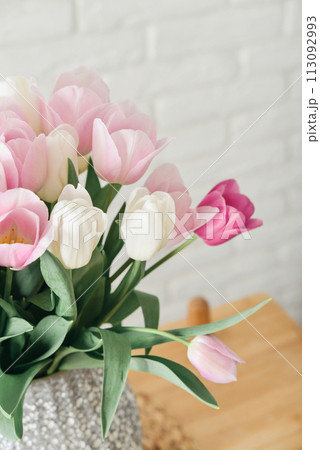 Bouquet of pink and white tulips in vase 113092993