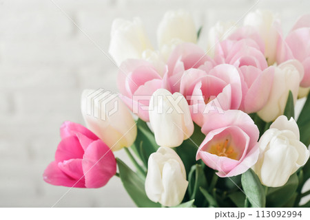 Bouquet of pink and white tulips in vase 113092994