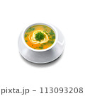 A comforting and hearty soup in a tall, slender glass bowl, garnished with fresh herbs and served with cr 113093208