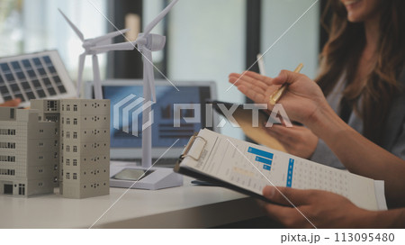Electrical engineer with businessman discussing new project installation solar cell panel on the roof of building. Alternative energy concept. Electrical engineer with businessman discussing new project installation solar cell panel on the roof of building. Alternative energy concept. 113095480